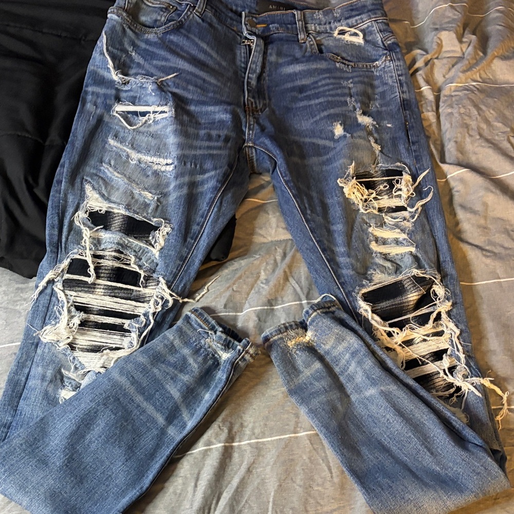 AMIRI Blue Denim Jeans with black and white patch
